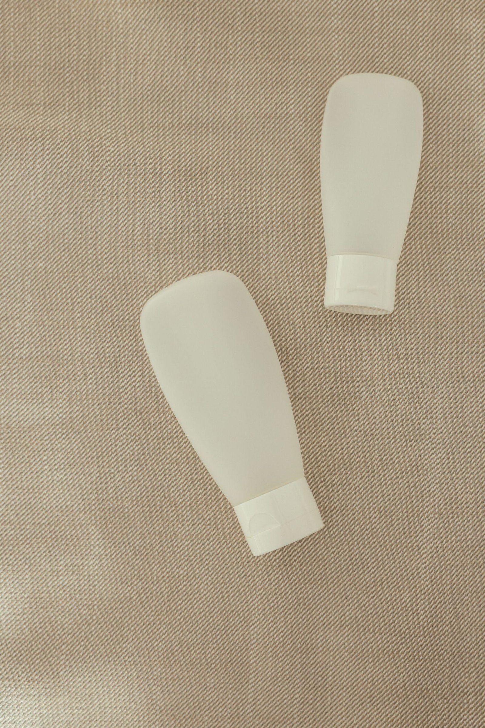 Two squeeze bottles on a textured surface