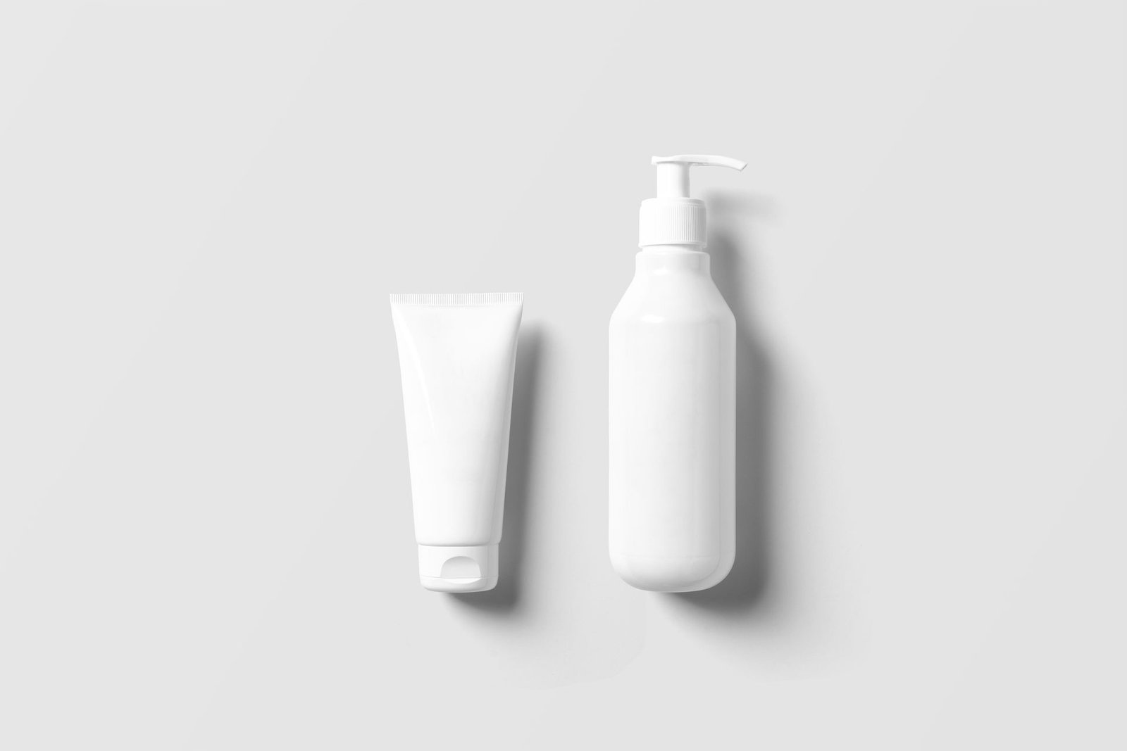 White pump bottle and tube on a white background