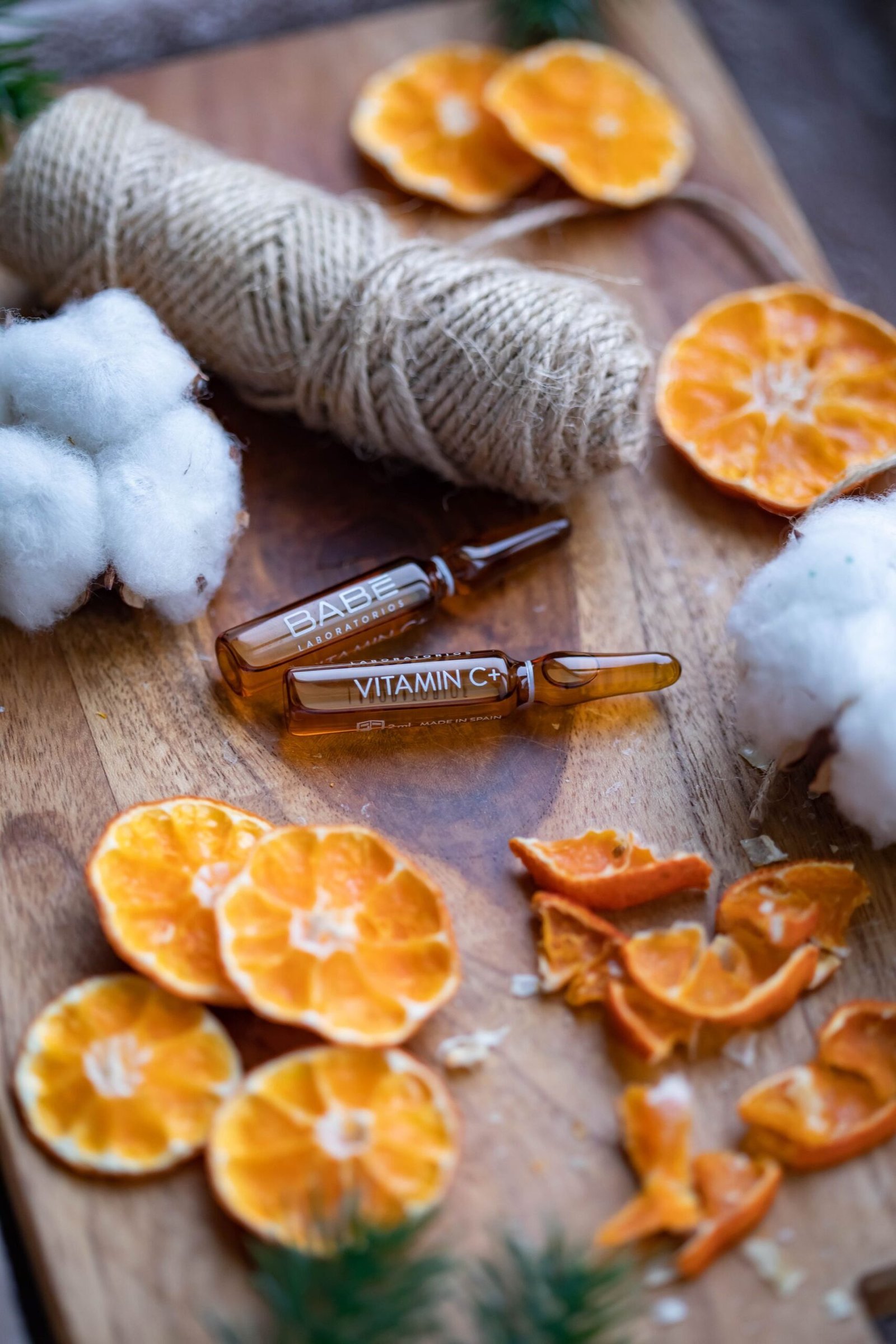 Serum ampoules with dried orange slices and cotton