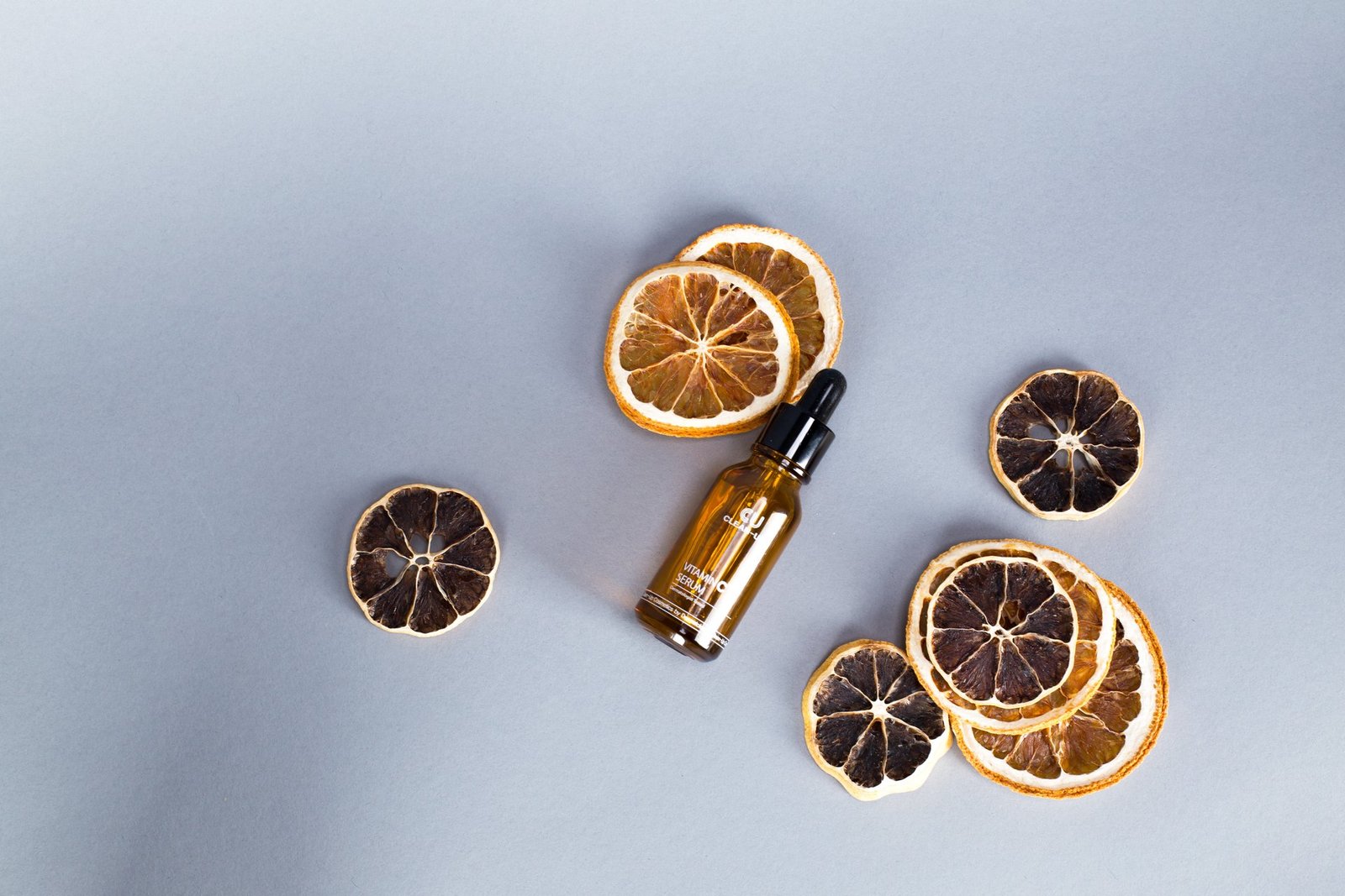 Serum dropper bottle with dried citrus slices