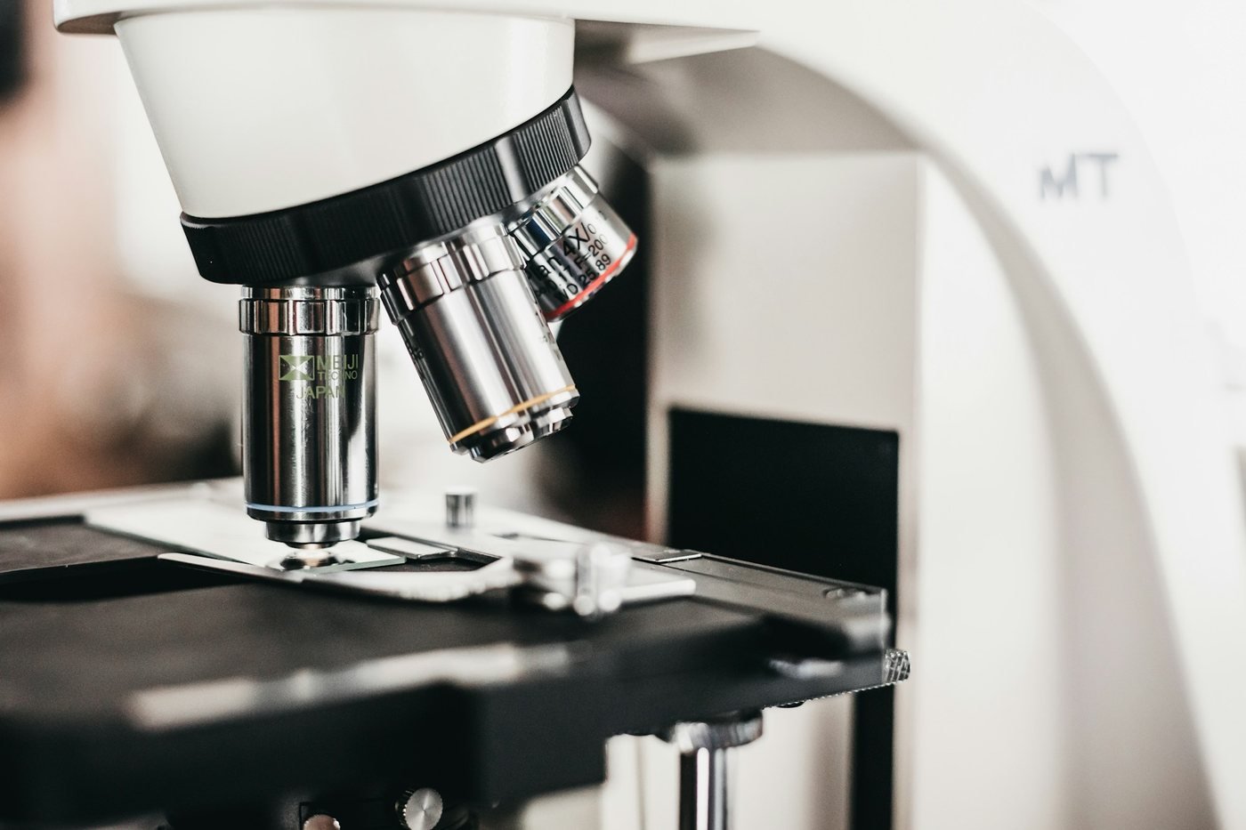 Laboratory microscope with objective lenses, used to identify the yeast behind fungal acne