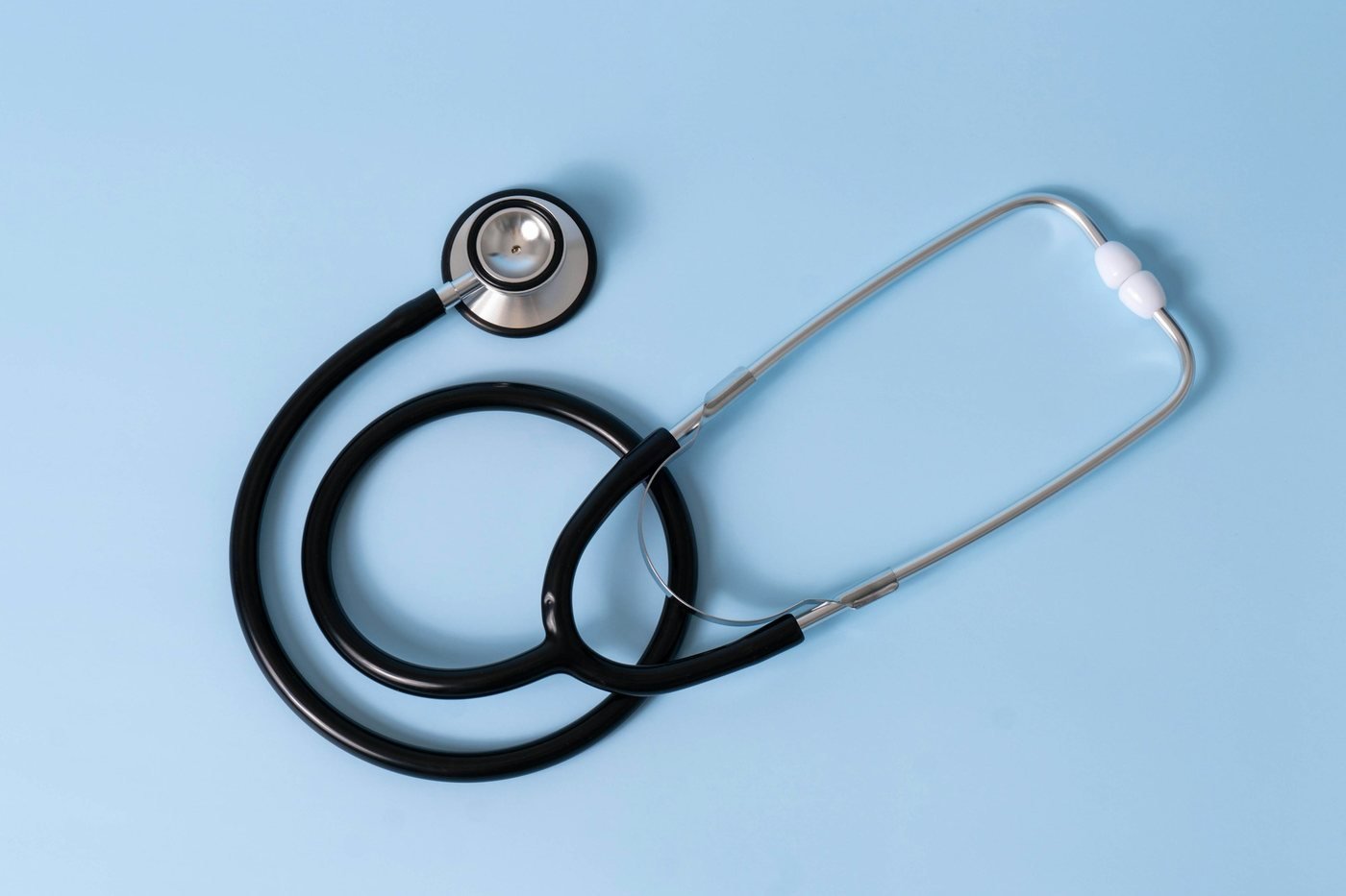 Stethoscope on a light blue background, a reminder to see a doctor for cystic acne